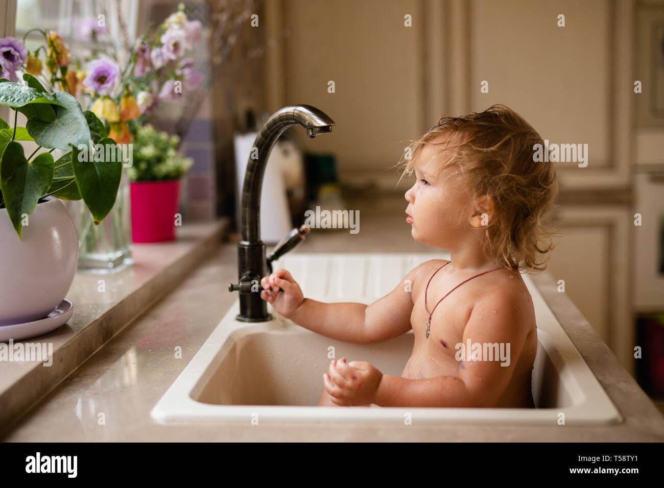 Images reveal baby playing in a sink, not published out of respect