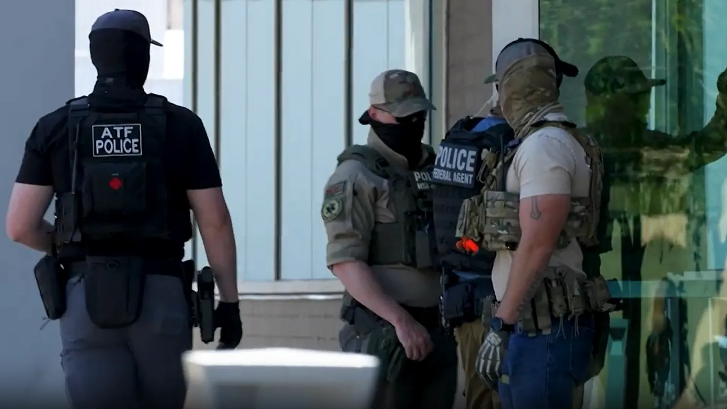 Masked ICE agents detain people as they leave immigration hearings in Phoenix May 21, 2025