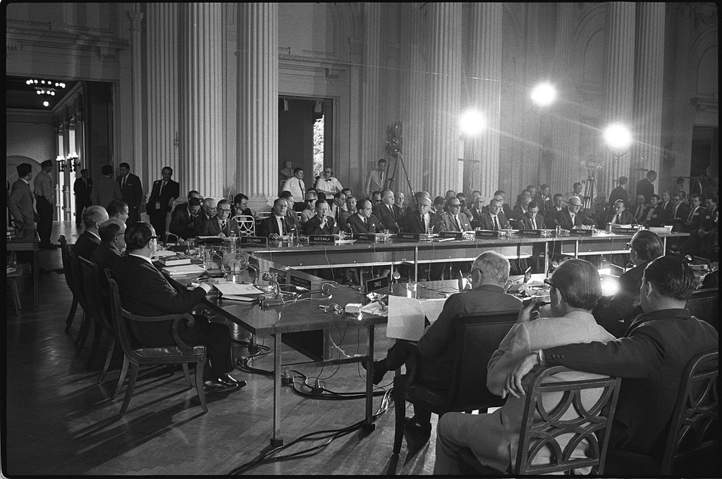 People seated around large tables during a meeting of the ...