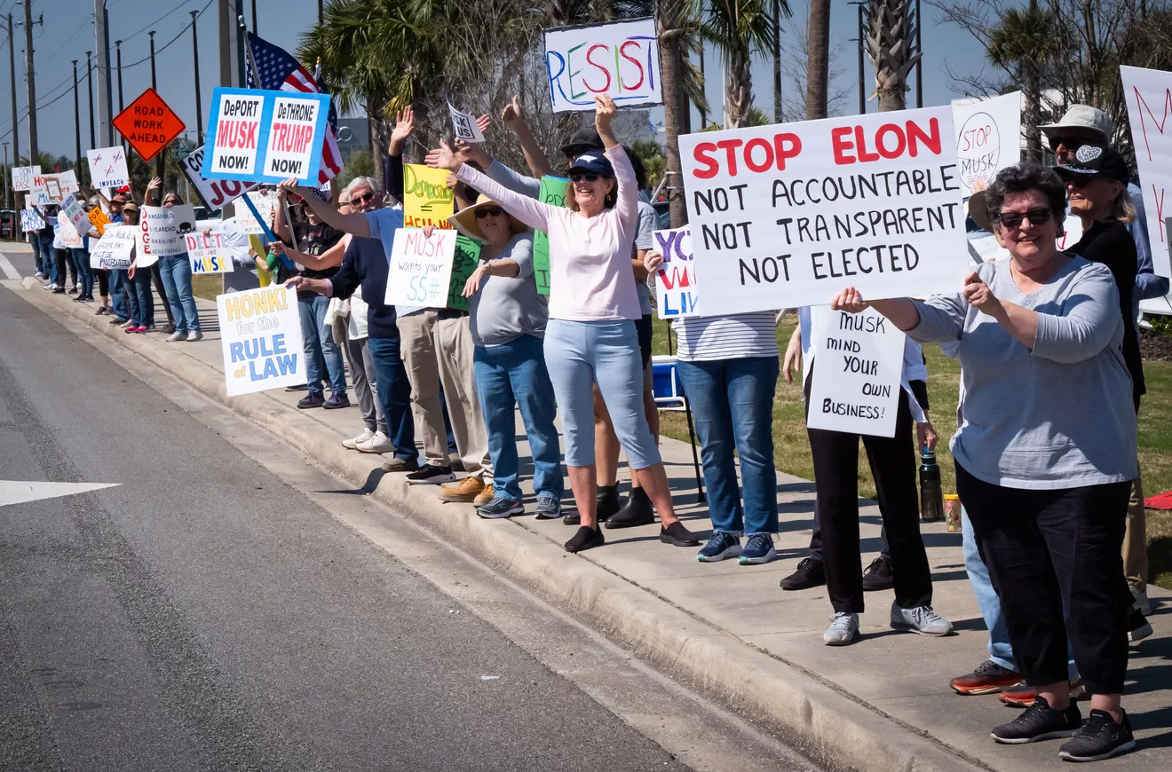Protestors rally against Elon Musk outside Florida Tesla dealership